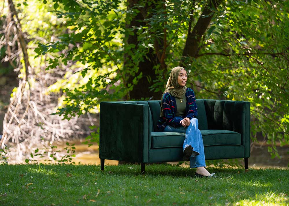 Person sitting on green couch