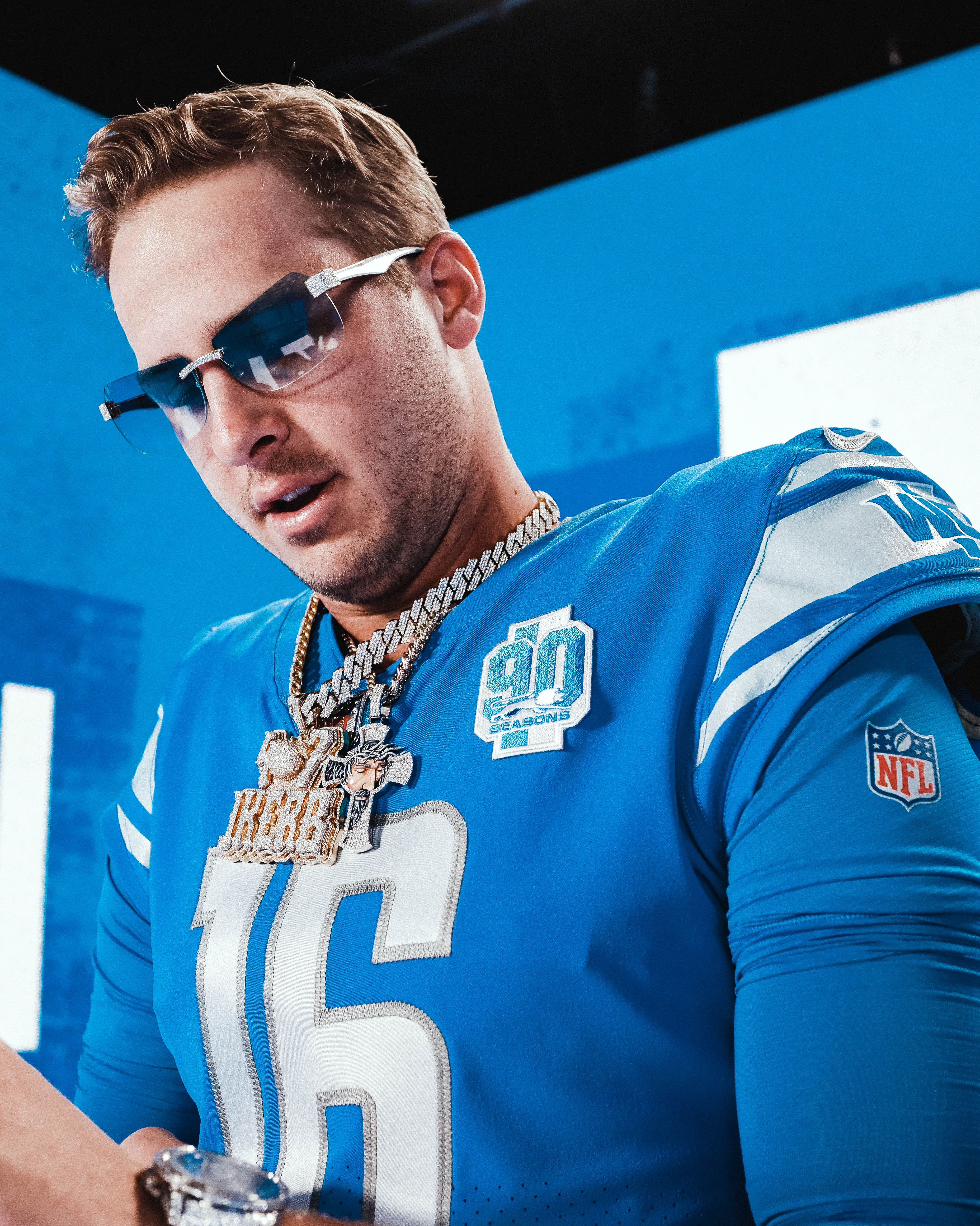 Jared Goff of the Detroit Lions in a jersey, jewelry and sunglasses.