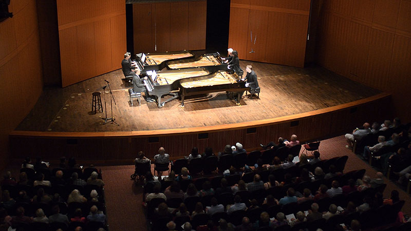 Four grand pianos share the stage as pianists from the MSU College of Music perform in the annual Piano Monster concert at the MSU Auditorium’s Fairchild Theatre.