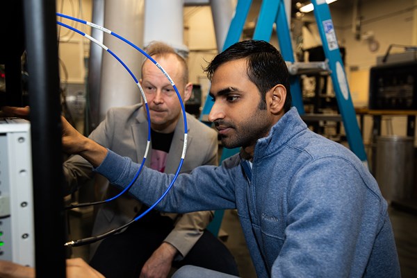 Prof. Johannes Pollanen (left) assists as Venture Fellow postdoc, Dr. Pranaya Rath, measures the resonant response of a high-quality factor three dimensional microwave cavity in MSU's Laboratory for Hybrid Quantum Systems. (photo: Gary Caldwell Productions)