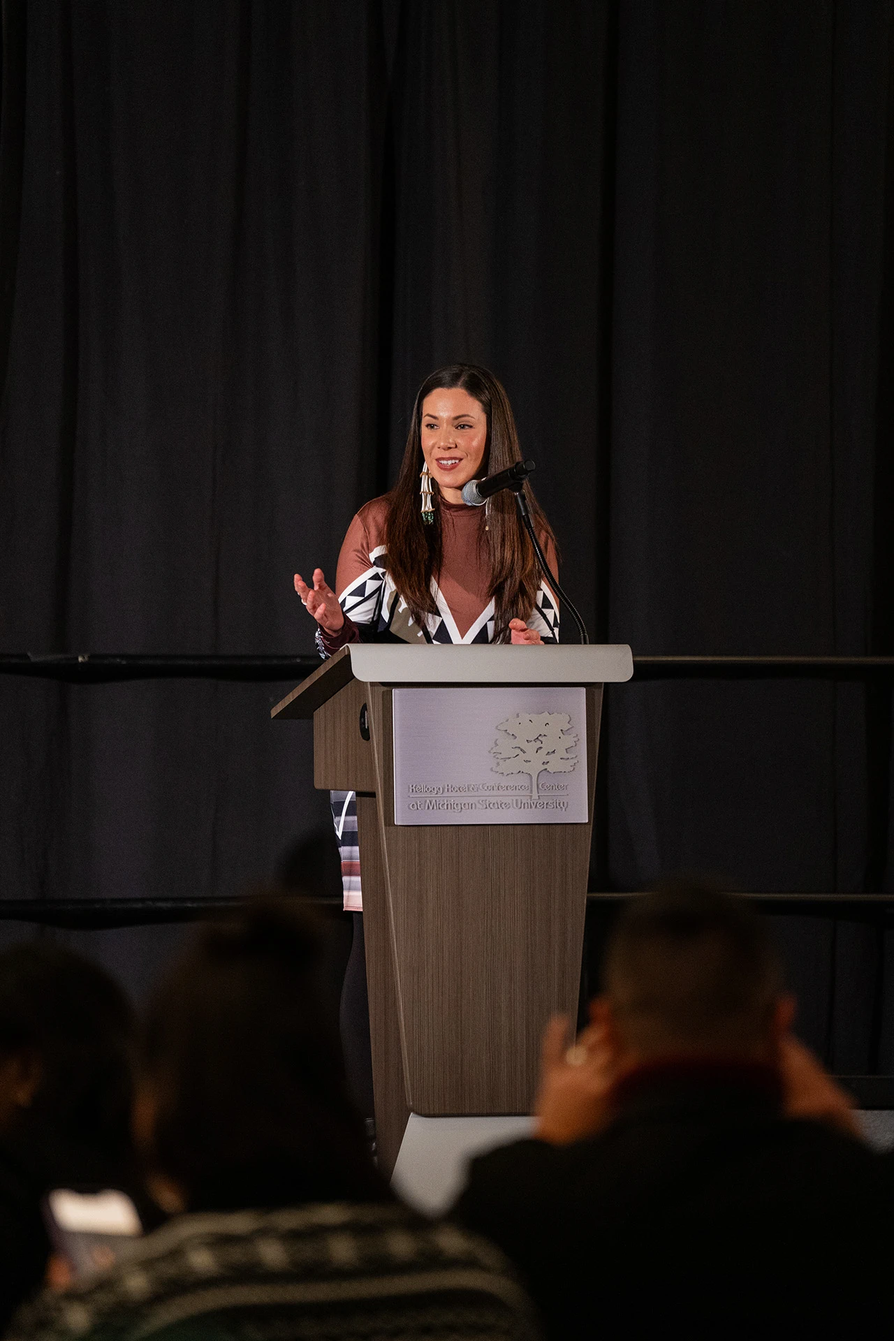 Blaire Moreseau standing a the lectern addressing the audience