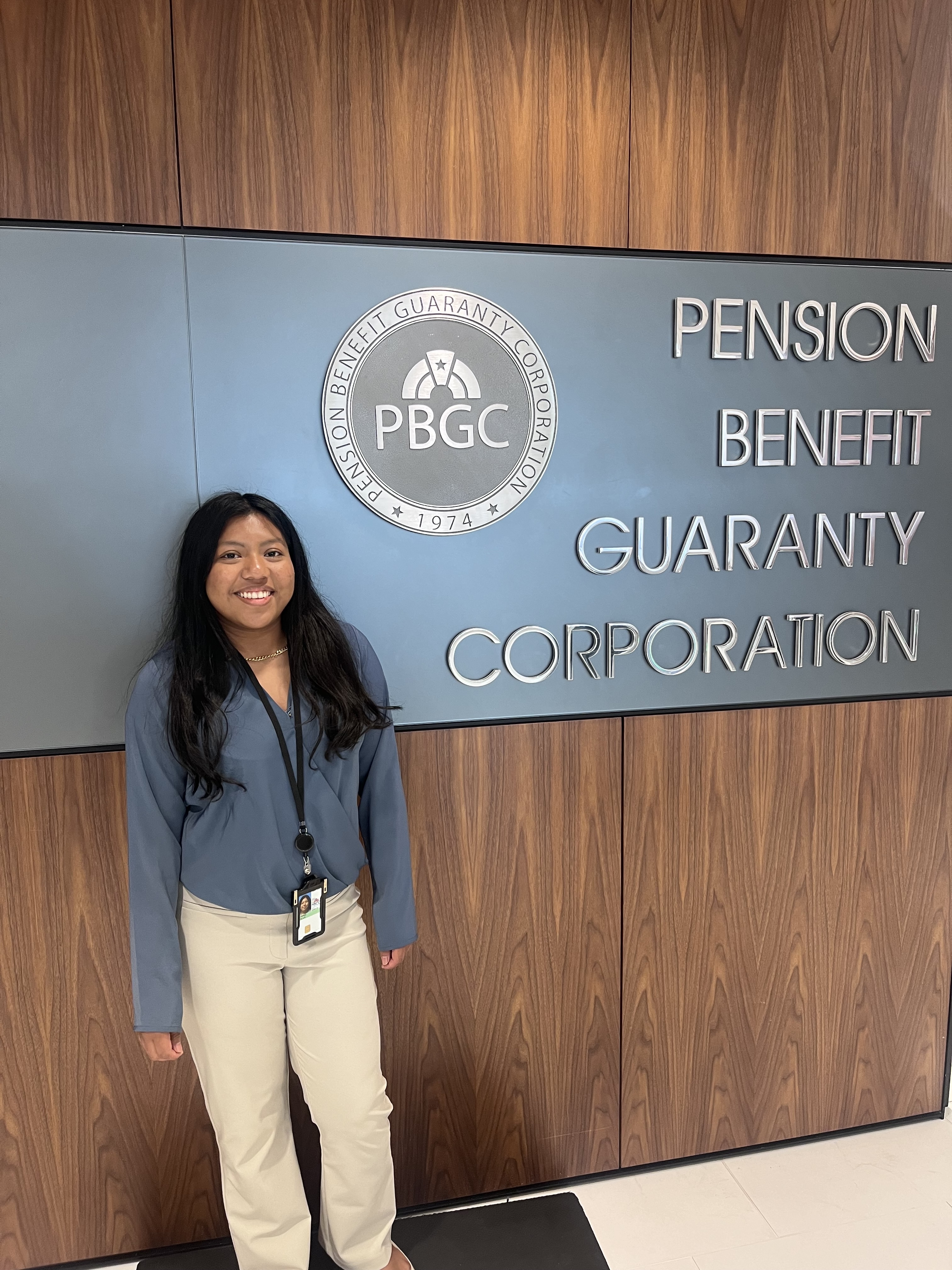 Perla Alvarez stands in front of the pension benefit guaranty corporation sign
