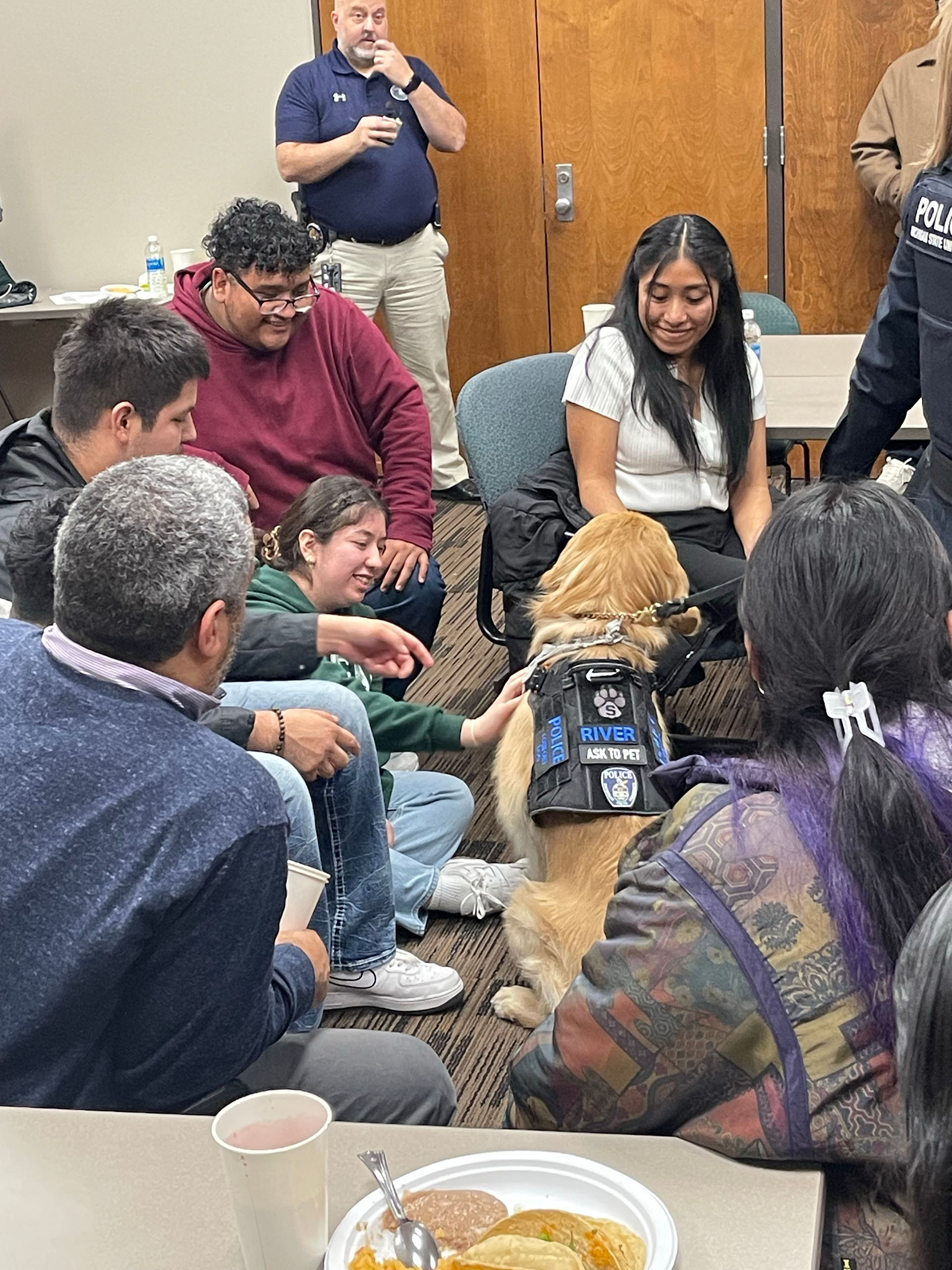 support dog River sits in the middle of students