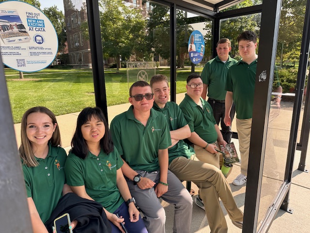 participants gathered in a CATA bus stop