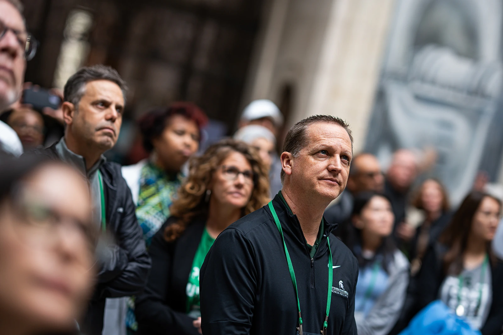 A group of people looking off camera to the right.