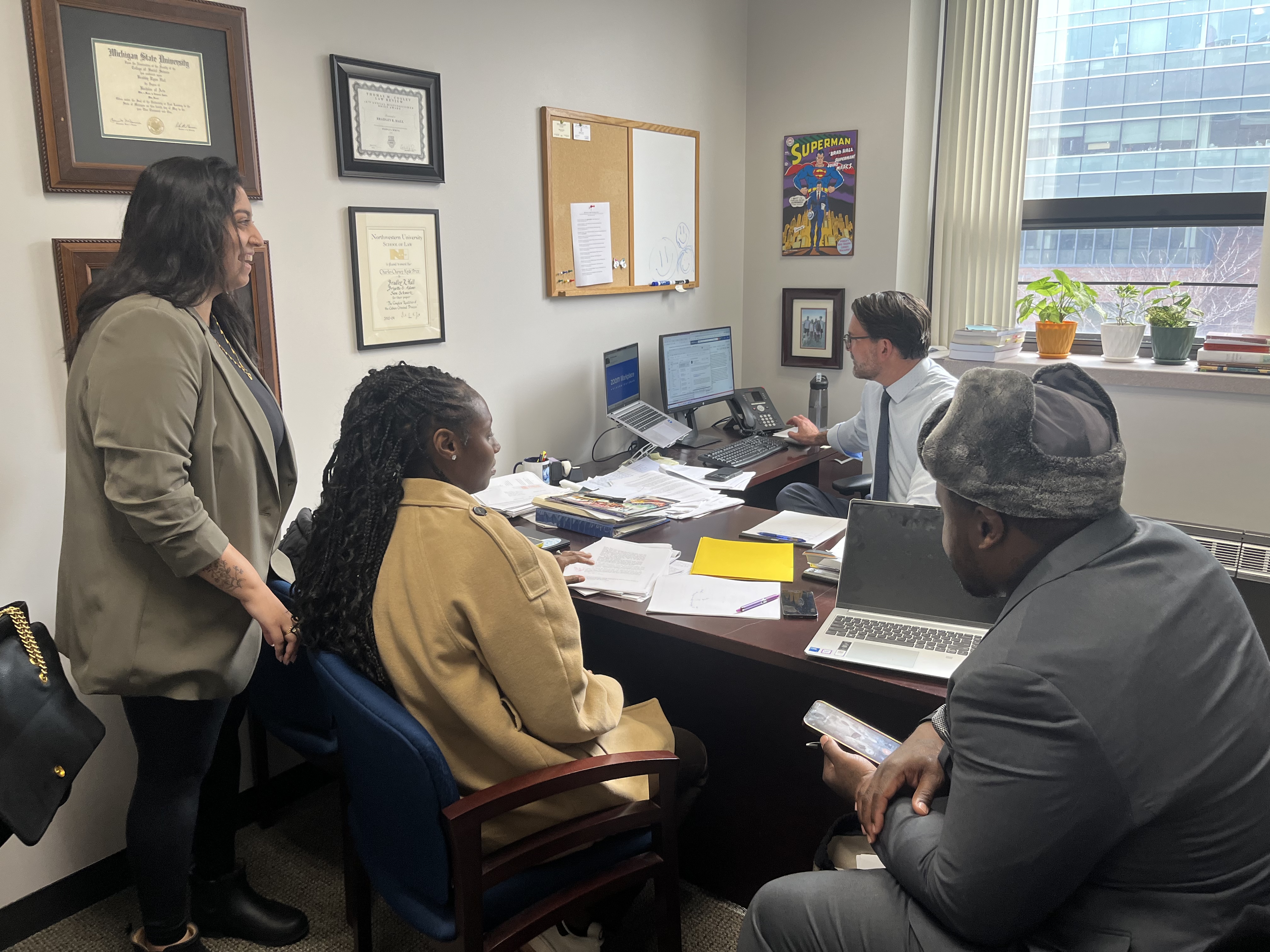 MSU law students Manisha Misra and Ravyn Lockridge meet with Professor Hall and a clinic client to discuss the client’s appeal.