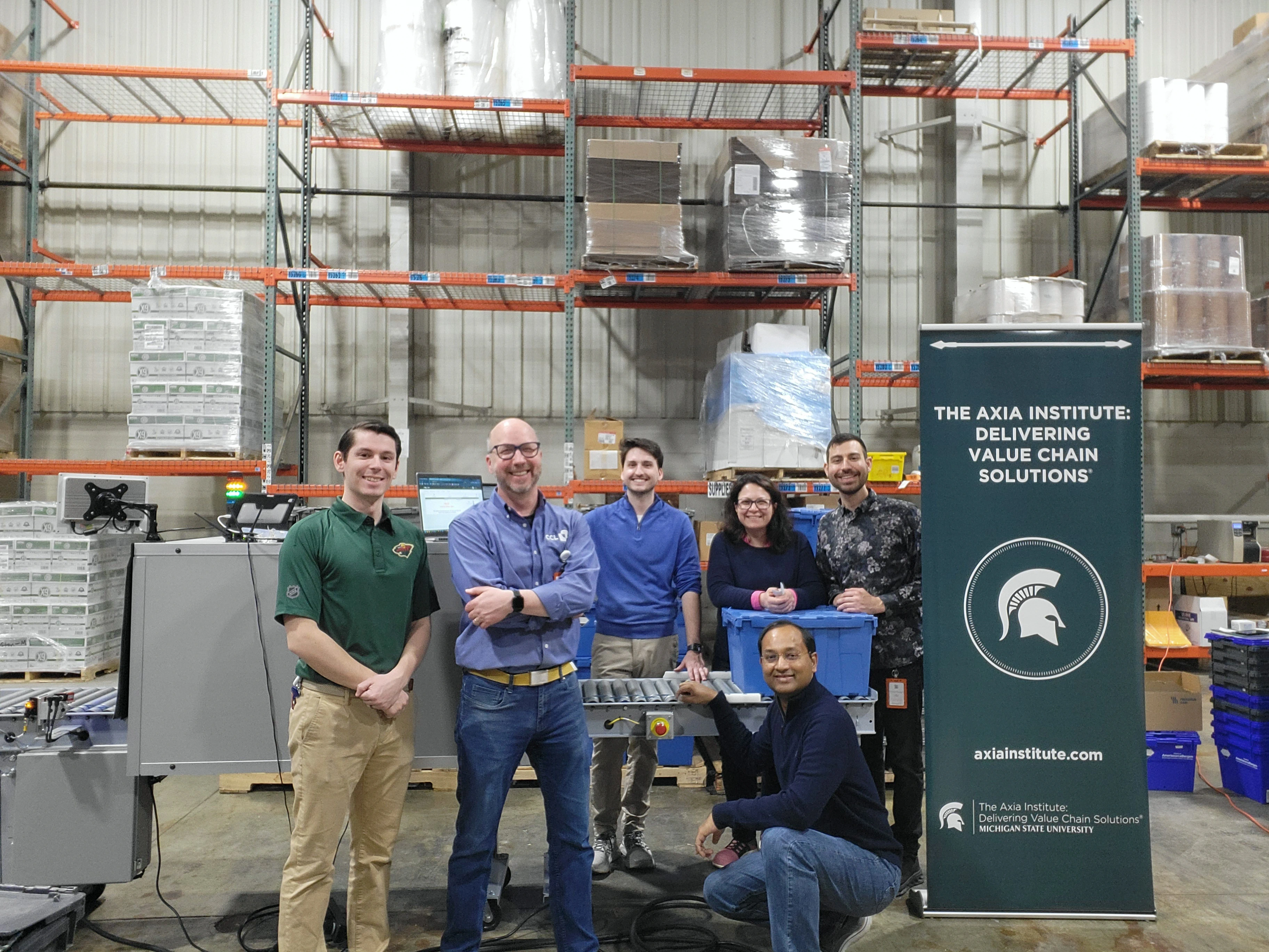 Photo credit: Cencora. The Pharma Pilot Phase 2 team at Cencora at their facility in Williamston, Mich. Pictured (left to right): Sean Murphy (Cencora), Aaron Sundman (CCL eAgile), Jack Stewart (CCL eAgile), Bahar Aliakbarian (Axia), Ethan Claucherty (Axia) and Vasu Saladi (Cencora).