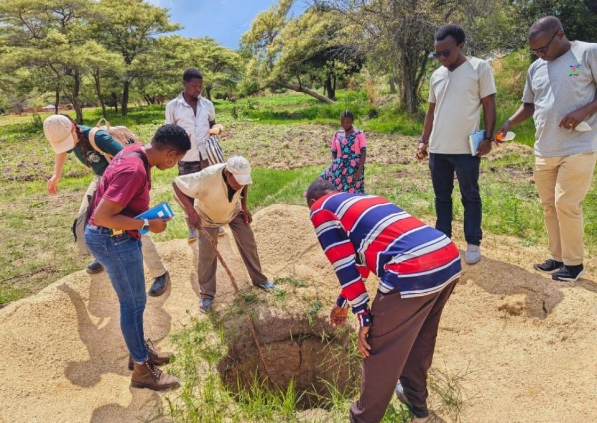 The team investigates existing wells.