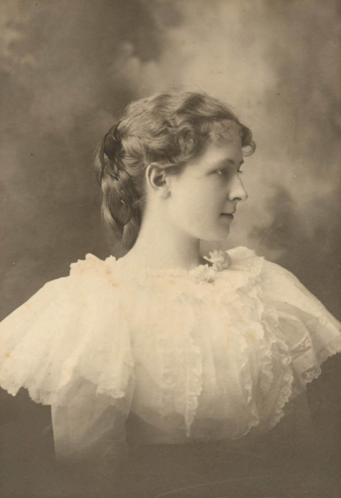 Portrait photo of Ella Pearl Kedzie Plant wearing white and looking to the side