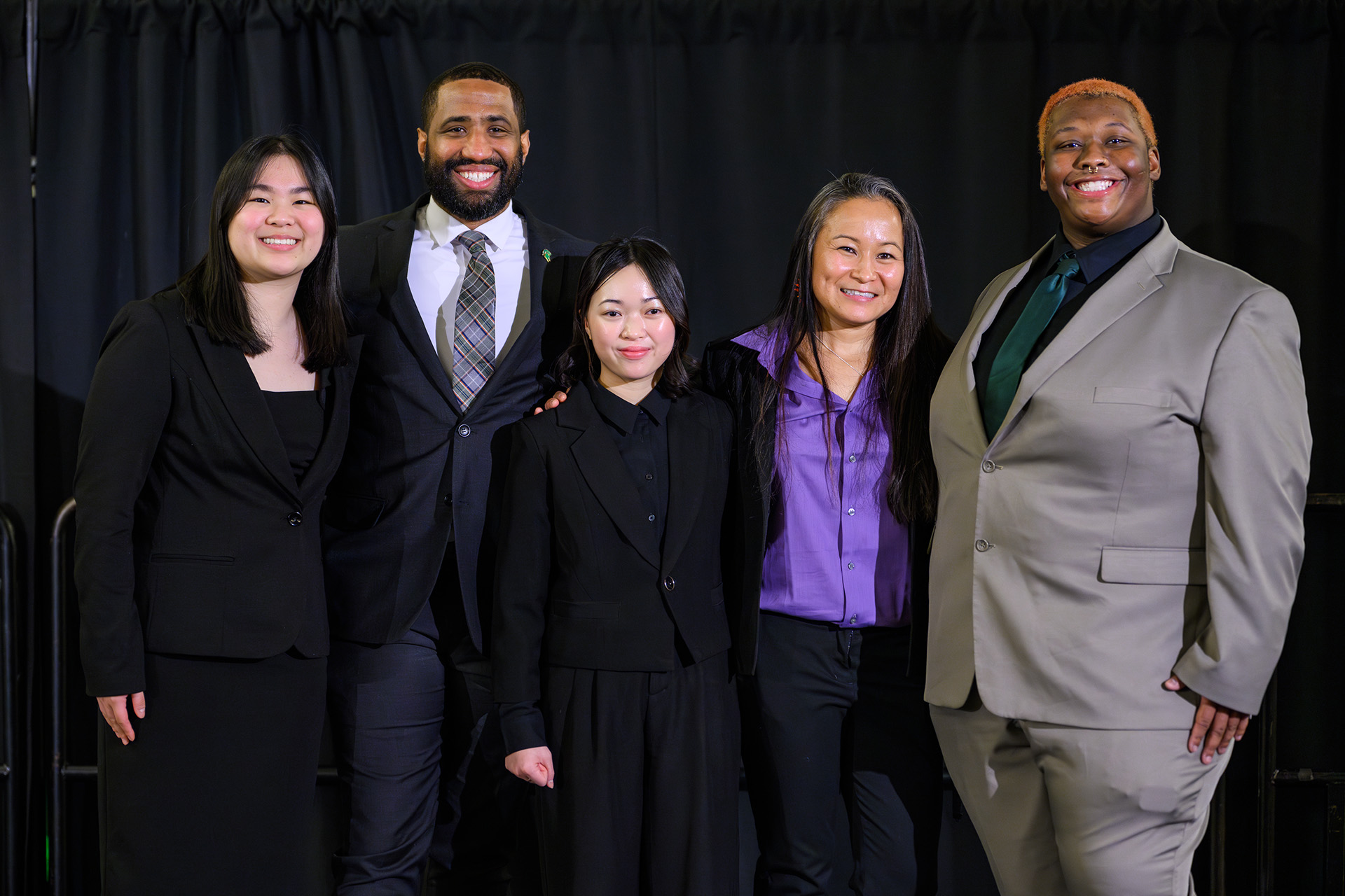 MLK Unity Dinner speakers pose for a photo on stage