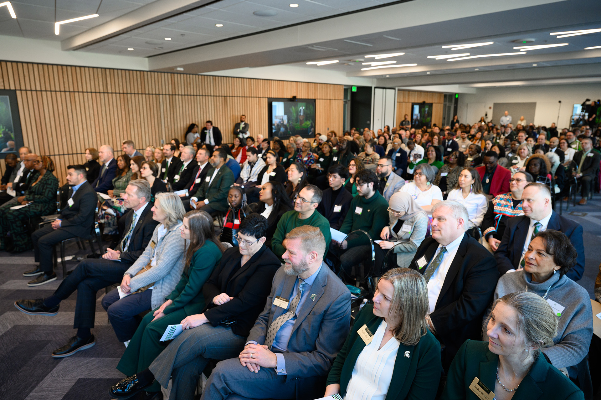 Large crowded room with people sitting