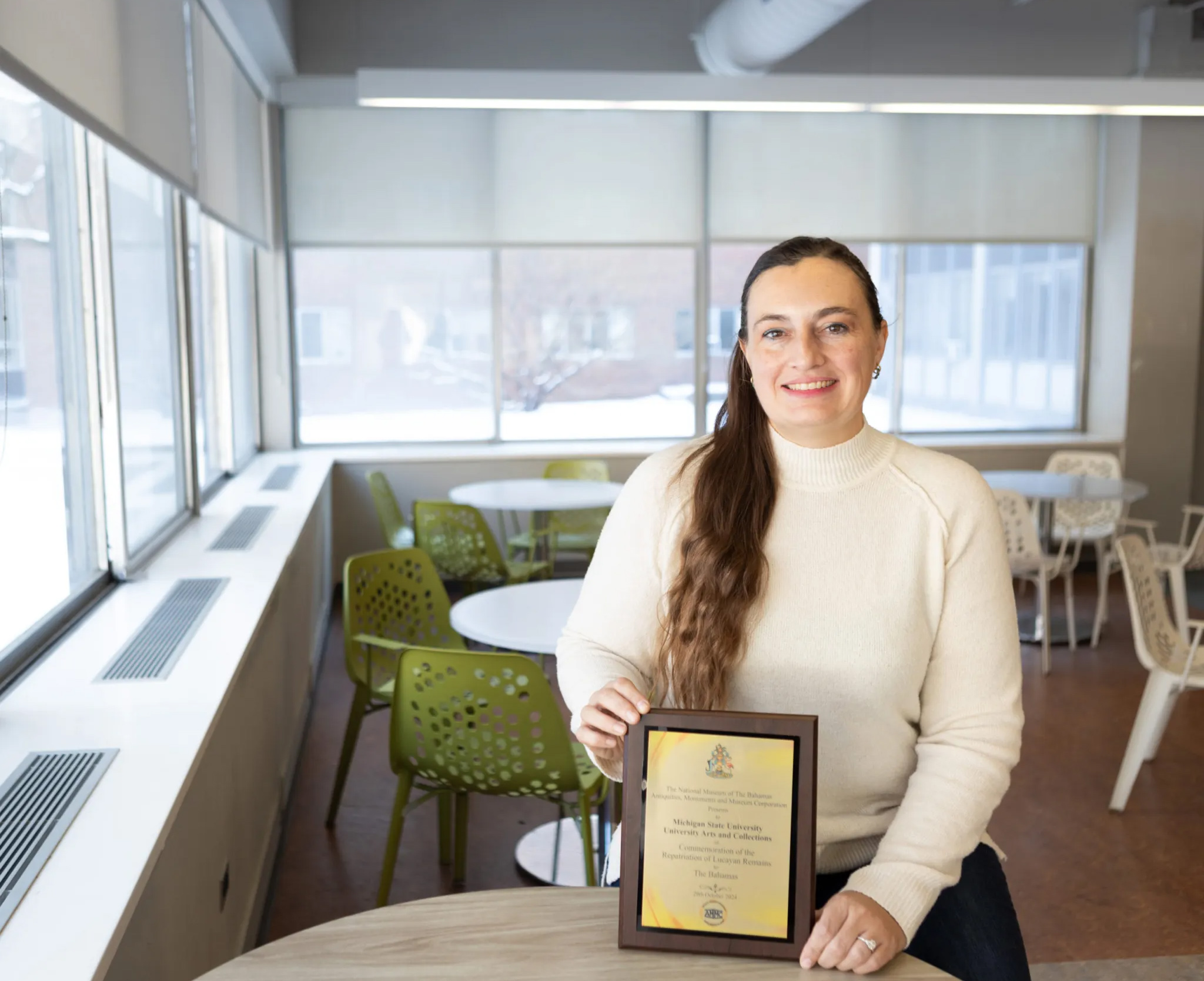 Dr. Jessica Yann with plaque from the National Museum of The Bahamas Antiquities