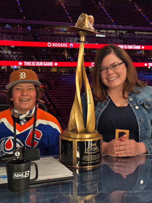 Sarah Dunkel-Jackson (right) accepts the Willie O’Ree Community Hero Award with her son. Credit Dunkel-Jackson.