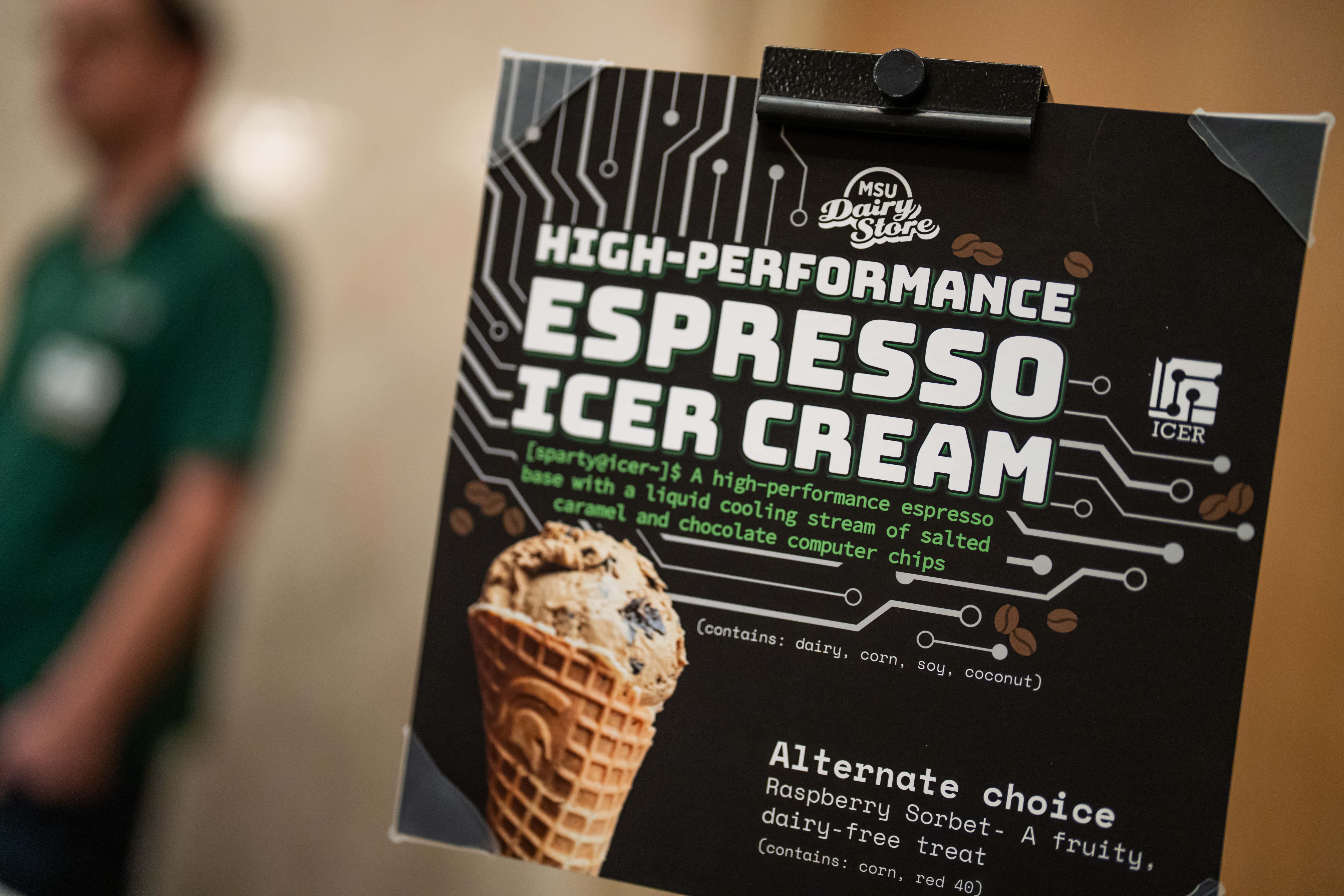 A dark sign with a photo of an ice cream cone and text that reads