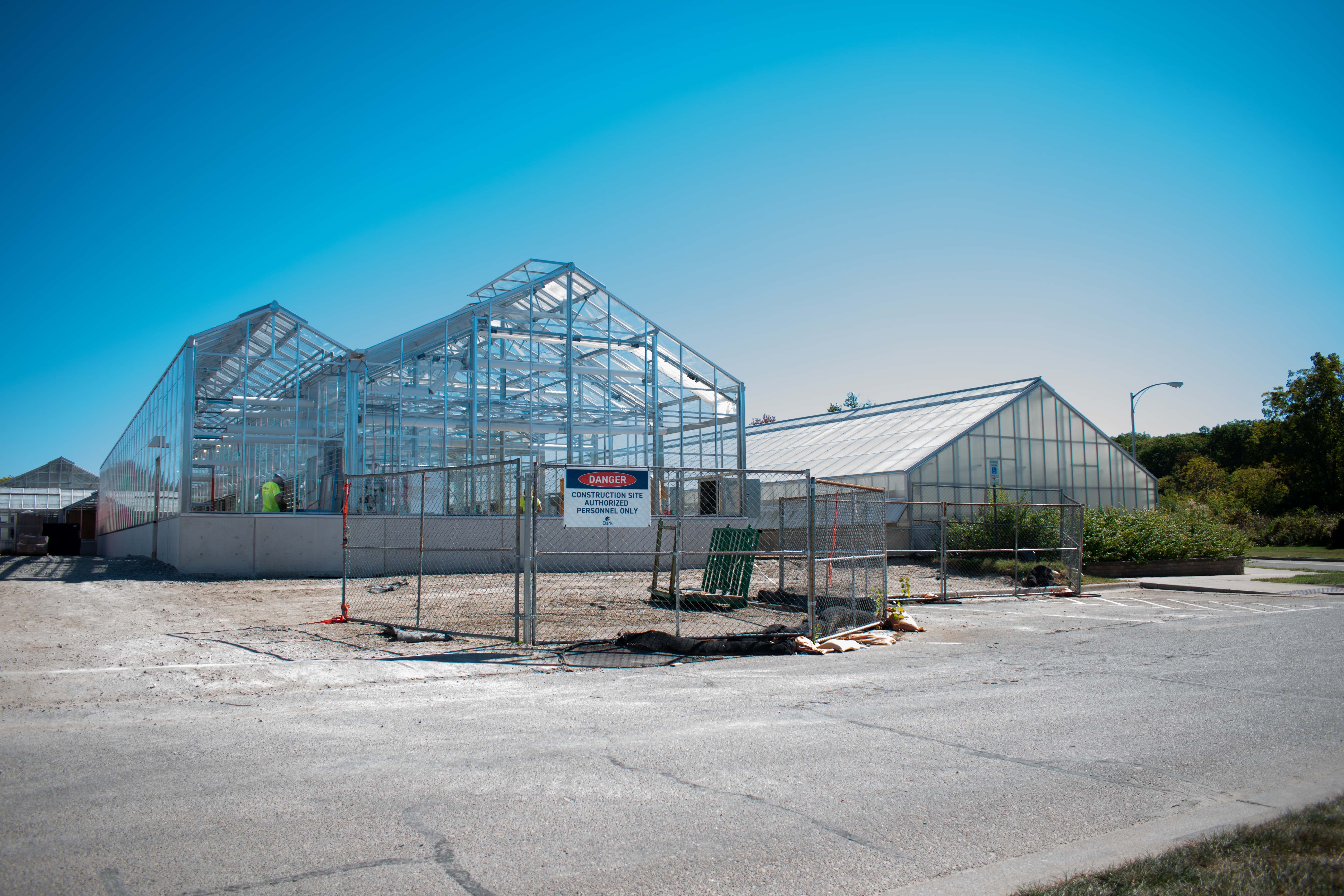 From left to right: A new greenhouse and an existing greenhouse at the MSU Plant Science Research Greenhouse Facility.