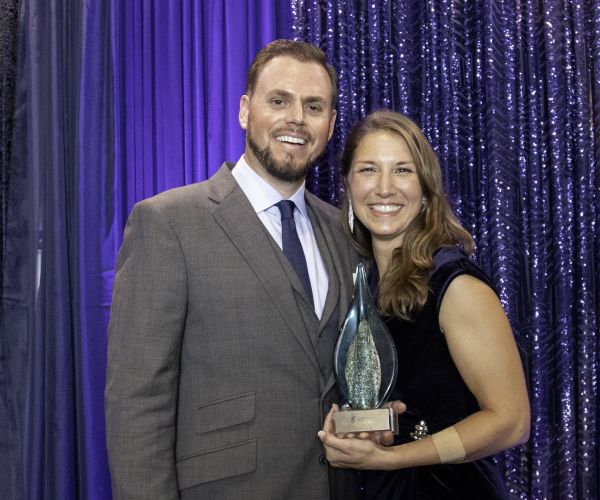Andrew and Monica Gauthier pose with a glass award.